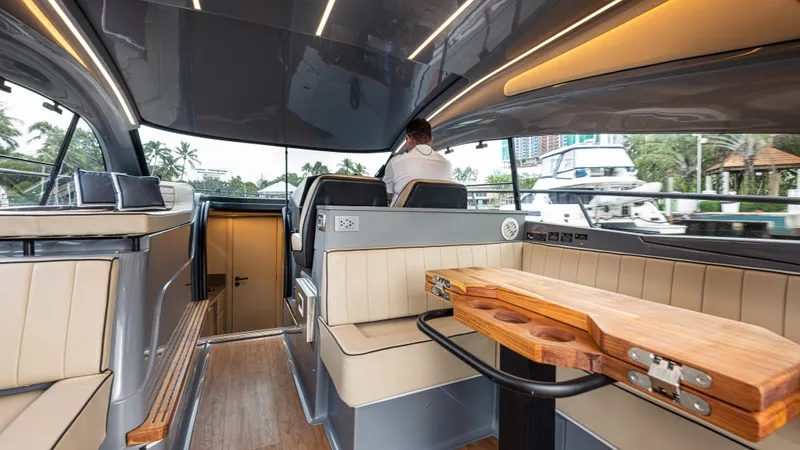 Slide: The Image of Luxurious interior of 2025 Hanover 415 yacht with modern seating and wooden table. - 19