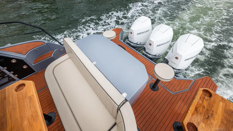 Slide: The Image of Luxurious boat, Hanover 415, 2026, with three outboard motors on wooden deck. - 34