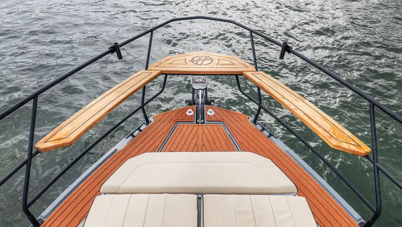 Slide: The Image of Front deck of a 2026 Hanover 415 boat with wooden trim. - 42