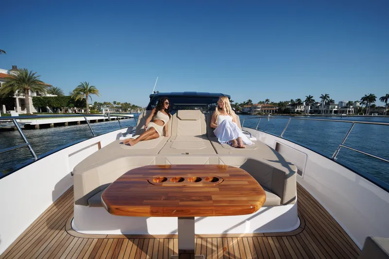 Slide: The Image of Luxury Hanover 447 yacht, 2026 model, with two women relaxing on deck, scenic waterfront view. - 25