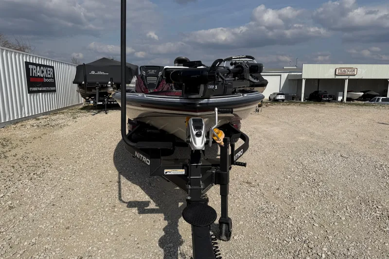 Slide: The Image of 2024 Nitro Z21 XL Pro boat on trailer at dealership, clear sky background. - 3