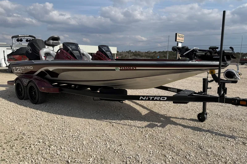 Slide: The Image of 2024 Nitro Z21 XL Pro boat on trailer, parked outdoors under cloudy sky. - 4
