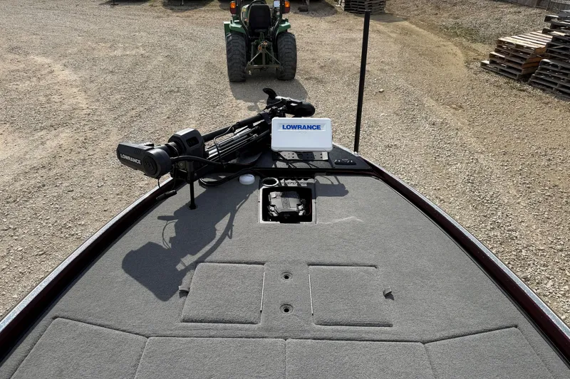 Slide: The Image of 2024 Nitro Z21 XL Pro boat deck with Lowrance equipment, parked on gravel. - 8