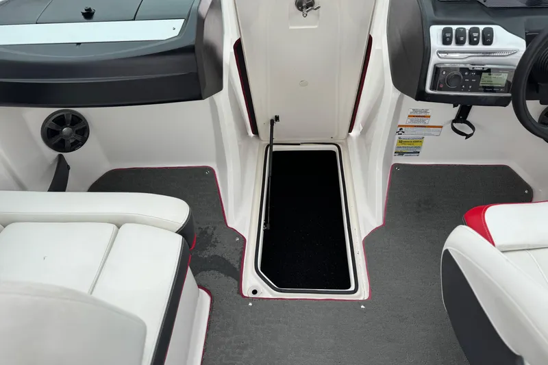 Slide: The Image of 2017 Regal 2000 ESX Bowrider interior with seating, control panel, and storage compartment. - 24