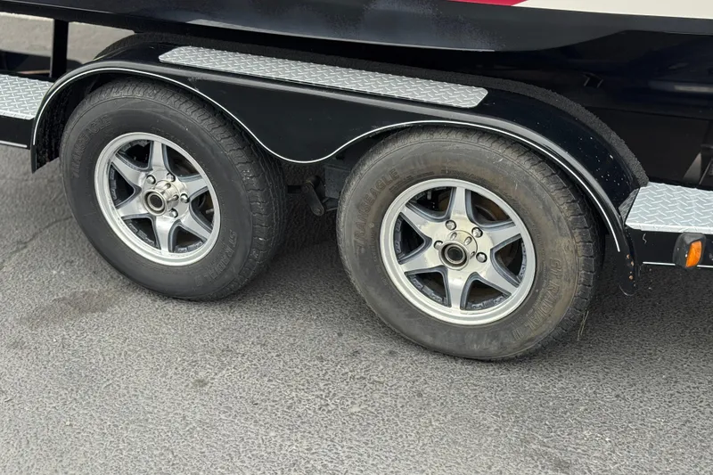 Slide: The Image of Trailer wheels of a 2017 Regal 2000 ESX Bowrider on asphalt surface. - 28