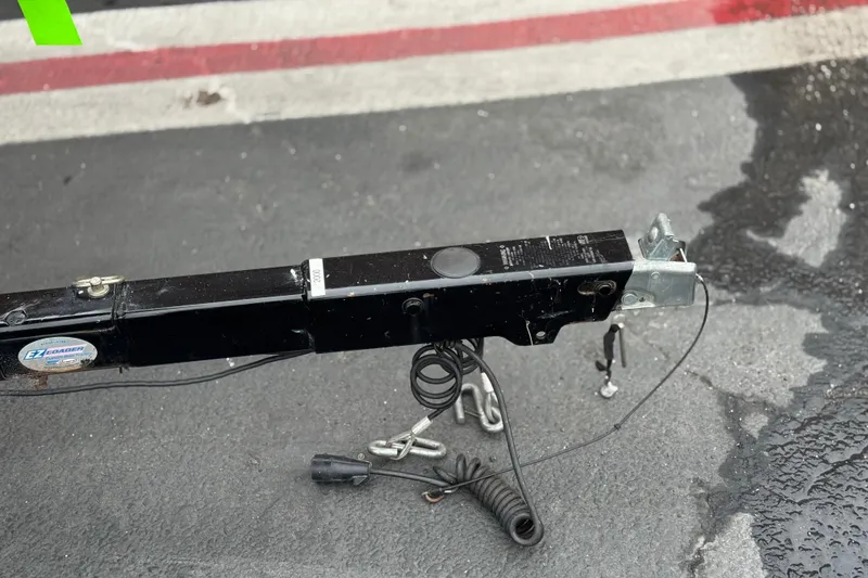 Slide: The Image of Trailer hitch of a 2017 Regal 2000 ESX Bowrider on wet pavement. - 29