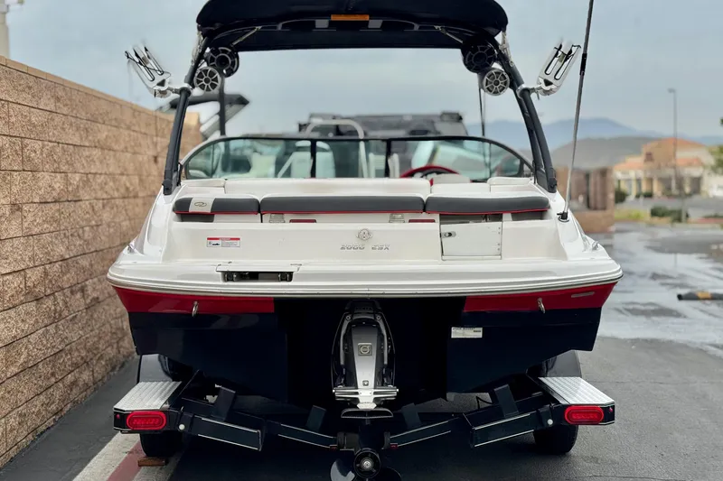 Slide: The Image of 2017 Regal 2000 ESX Bowrider boat on trailer, rear view, parked outdoors. - 4