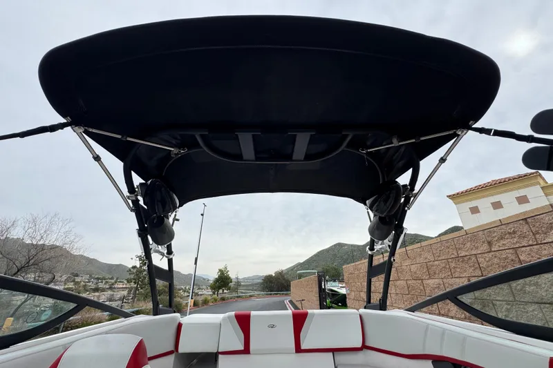 Slide: The Image of 2017 Regal 2000 ESX Bowrider with black canopy and red-accented seating. - 9