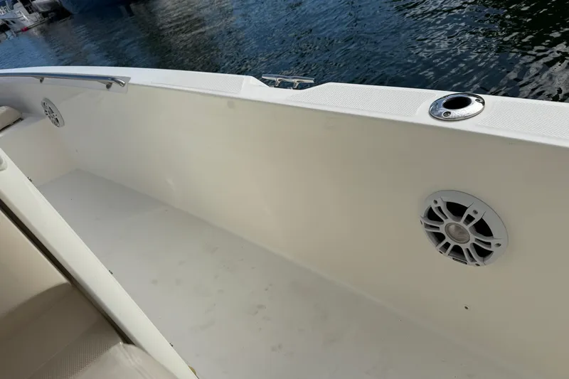 Slide: The Image of 2018 Boston Whaler 270 Dauntless boat interior with speaker and rod holder. - 13