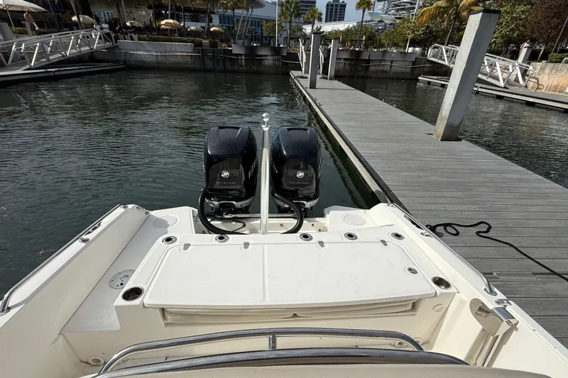 Slide: The Image of 2018 Boston Whaler 270 Dauntless docked with dual outboard engines. - 19