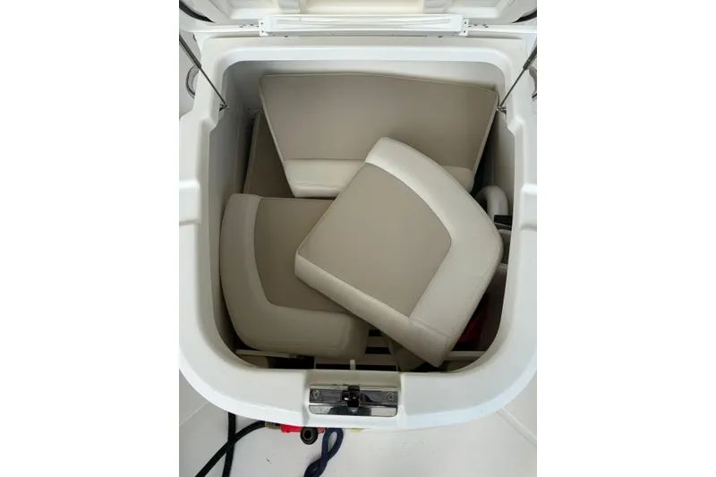 Slide: The Image of Storage compartment with beige cushions on a 2018 Boston Whaler 270 Dauntless boat. - 25