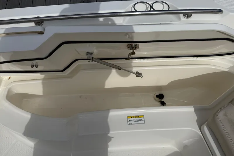 Slide: The Image of 2018 Boston Whaler 270 Dauntless boat interior with storage compartment and faucet. - 26