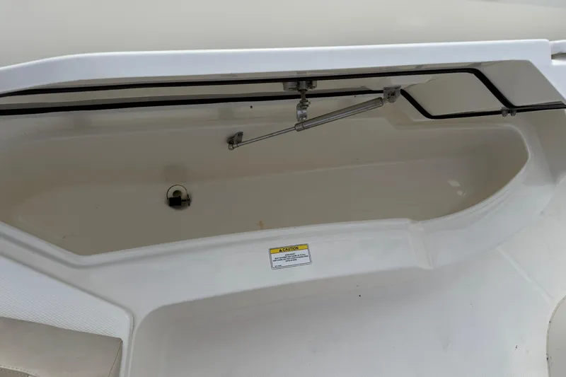 Slide: The Image of Open storage compartment on a 2018 Boston Whaler 270 Dauntless boat. - 28