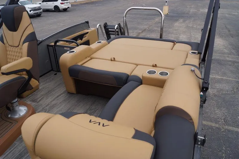 Slide: The Image of 2026 Avalon Catalina Versatile Rear Bench boat interior with luxurious tan seating and cup holders. - 16
