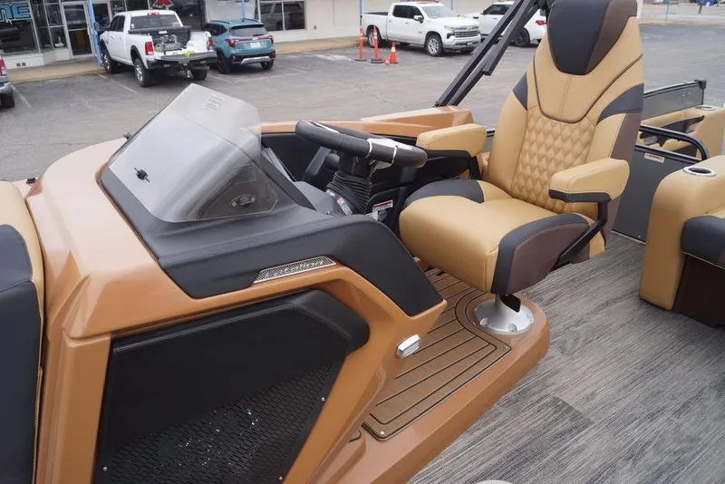 Slide: The Image of 2026 Avalon Catalina Versatile Rear Bench boat interior with luxurious captain's chair and dashboard. - 17