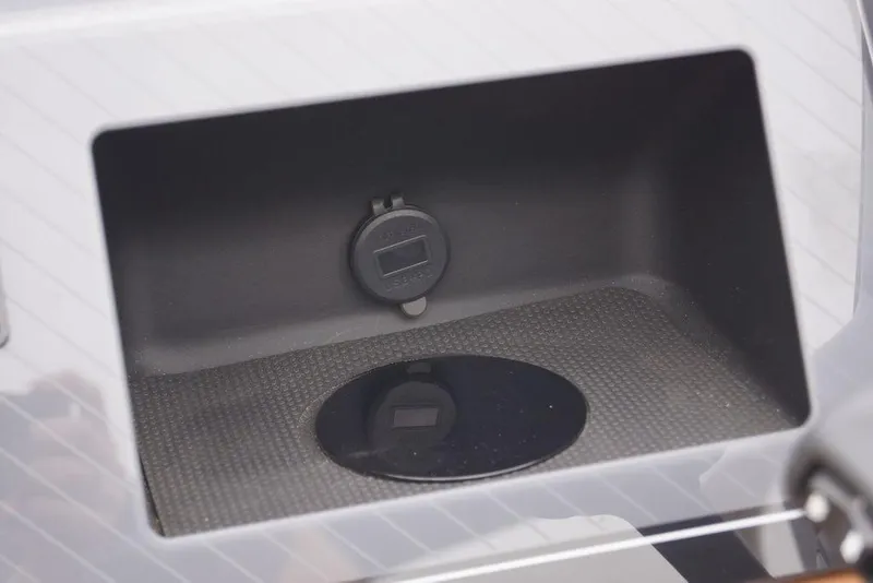 Slide: The Image of Storage compartment with power outlet in 2026 Avalon Catalina Versatile Rear Bench boat. - 18