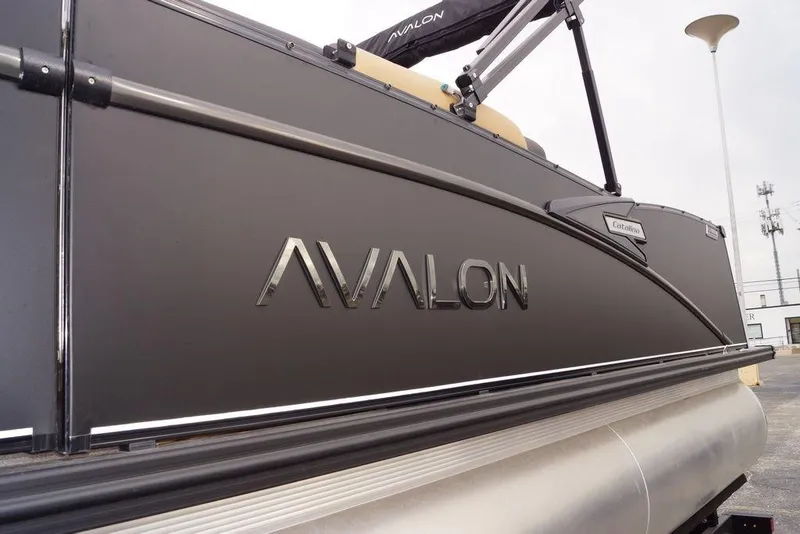 Slide: The Image of 2026 Avalon Catalina Versatile Rear Bench pontoon boat, sleek design, side view. - 2
