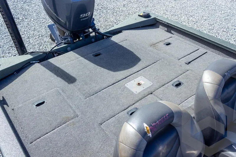 Slide: The Image of 2015 Xpress H17 boat interior with Yamaha 90 engine, featuring carpeted deck and seating. - 23