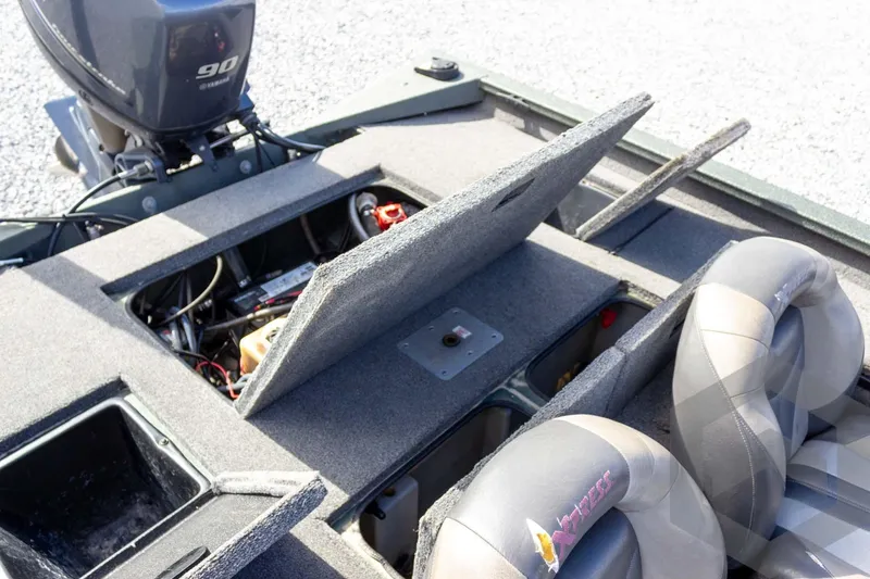 Slide: The Image of 2015 Xpress H17 boat interior with open storage compartments and Yamaha 90 engine. - 24
