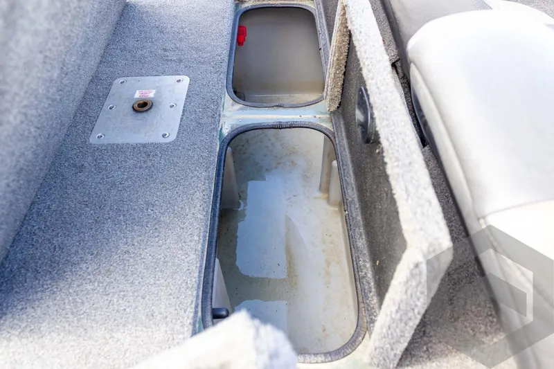 Slide: The Image of Interior storage compartments of a 2015 Xpress H17 boat, featuring carpeted surfaces. - 25