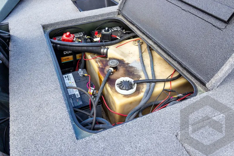 Slide: The Image of Open compartment of 2015 Xpress H17 boat showing battery and fuel tank. - 27