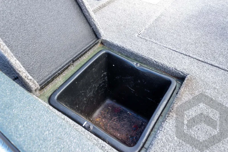 Slide: The Image of Open storage compartment in 2015 Xpress H17 boat, featuring carpeted interior. - 28