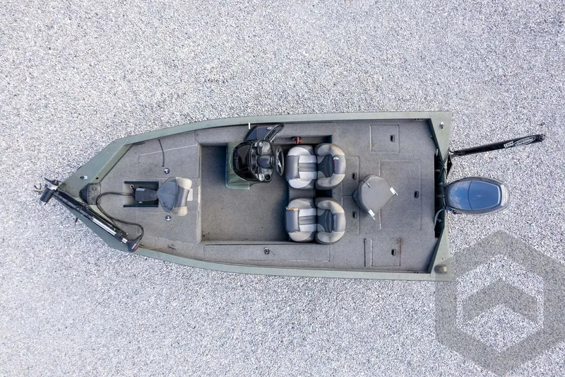 Slide: The Image of 2015 Xpress H17 boat, aerial view, showing seating and layout on gravel surface. - 29