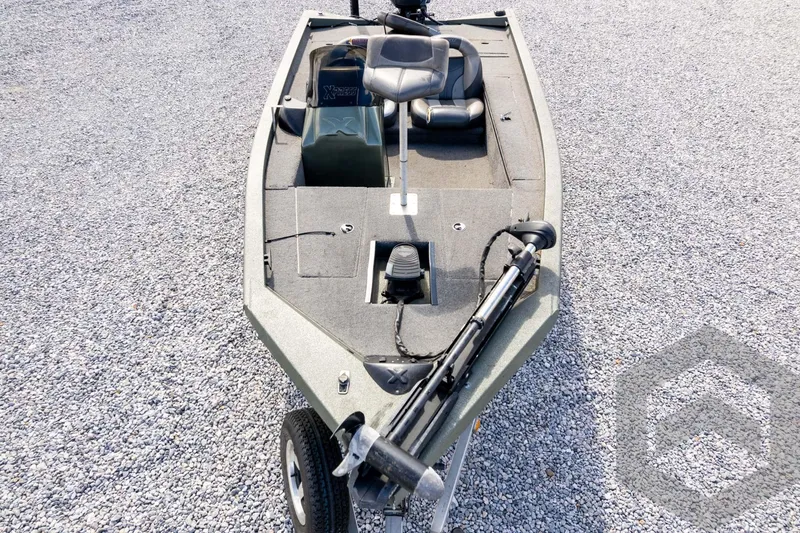 Slide: The Image of 2015 Xpress H17 boat on gravel, featuring a trolling motor and seating. - 39