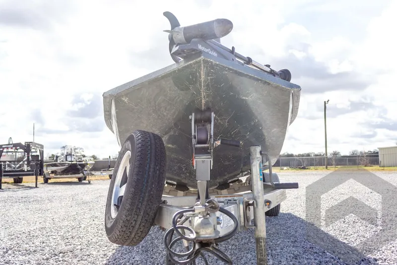 Slide: The Image of 2015 Xpress H17 boat on trailer, parked on gravel lot under cloudy sky. - 6
