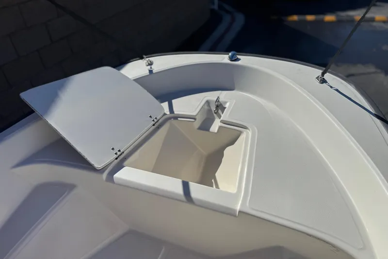 Slide: The Image of Open storage compartment on a 2000 Boston Whaler 13 Sport boat deck. - 10