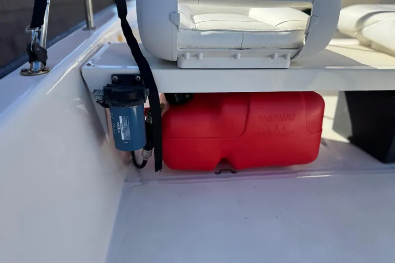 Slide: The Image of Boston Whaler 13 Sport 2000 boat interior with red fuel tank and filter. - 14
