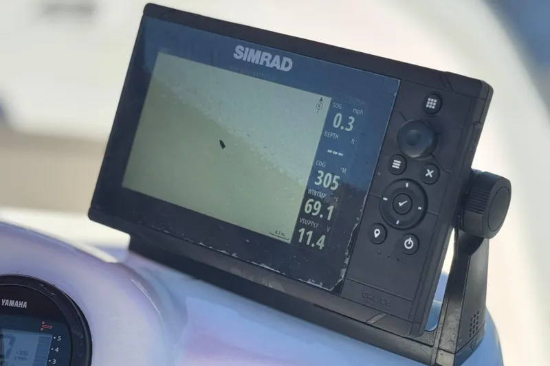 Slide: The Image of Simrad marine GPS display on a 2000 Boston Whaler 13 Sport boat dashboard. - 18