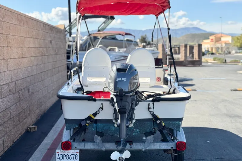 Slide: The Image of 2000 Boston Whaler 13 Sport boat with Yamaha 25 engine on trailer, red canopy. - 4