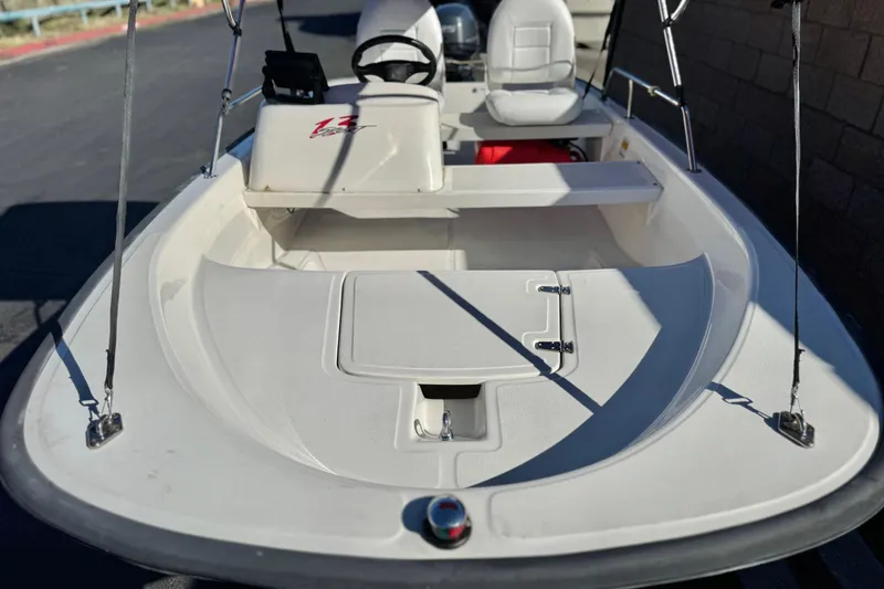 Slide: The Image of 2000 Boston Whaler 13 Sport boat interior with seating and storage compartments. - 8