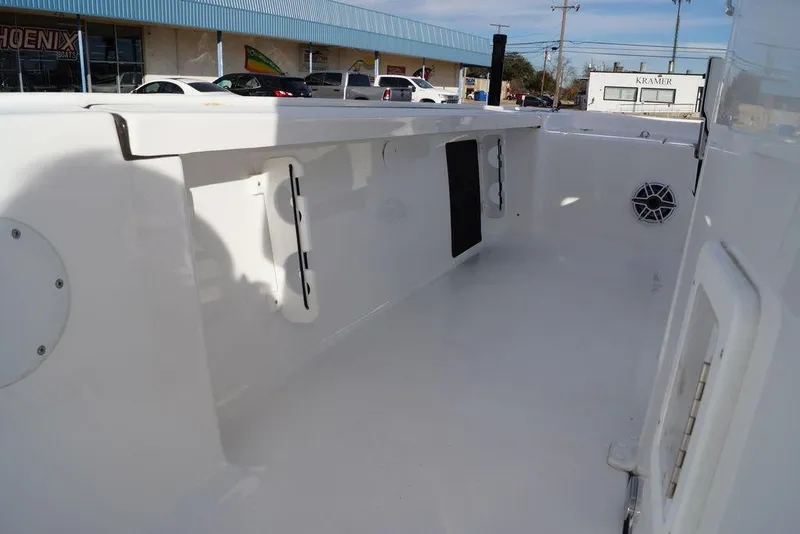 Slide: The Image of 2026 Tidewater 2410 Bay Max boat interior, featuring spacious white deck and storage compartments. - 12