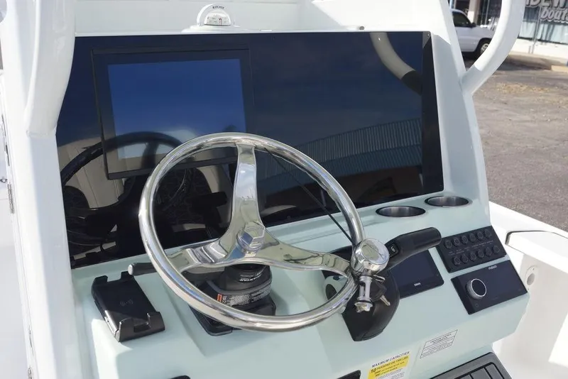 Slide: The Image of Helm of 2026 Tidewater 2410 Bay Max boat with steering wheel and controls. - 15