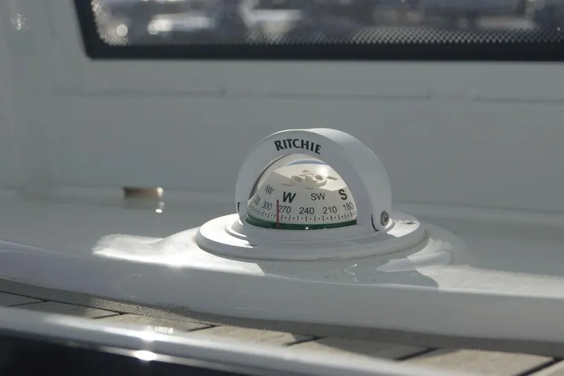 Slide: The Image of Compass on 2026 Tidewater 2410 Bay Max boat, displaying cardinal directions. - 20