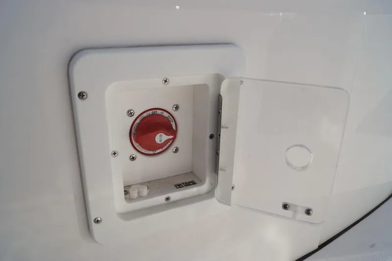 Slide: The Image of 2026 Tidewater 2410 Bay Max boat battery switch compartment with open cover. - 23