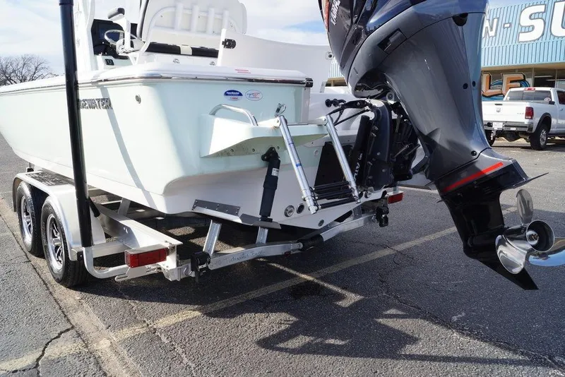 Slide: The Image of 2026 Tidewater 2410 Bay Max boat on trailer with outboard motor in parking lot. - 7