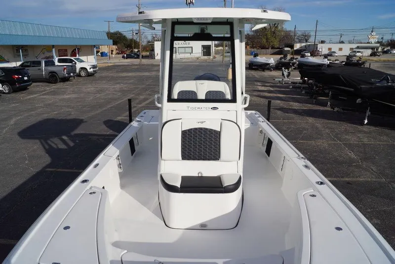 Slide: The Image of 2026 Tidewater 2410 Bay Max boat, white interior, parked outdoors in a dealership lot. - 8