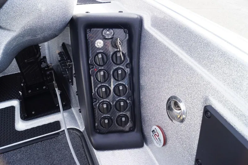 Slide: The Image of Control panel of 2026 Phoenix 721 ZXL boat with switches and key. - 14