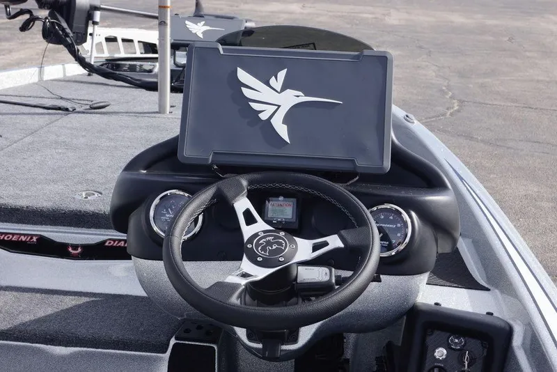 Slide: The Image of 2026 Phoenix 721 ZXL boat dashboard with steering wheel and digital display. - 15