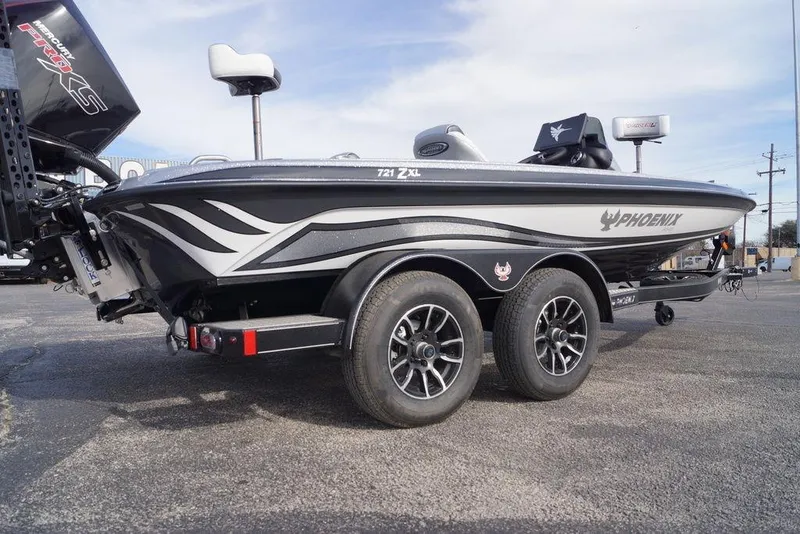 Slide: The Image of 2026 Phoenix 721 ZXL boat on trailer, featuring sleek design and dual axles. - 28