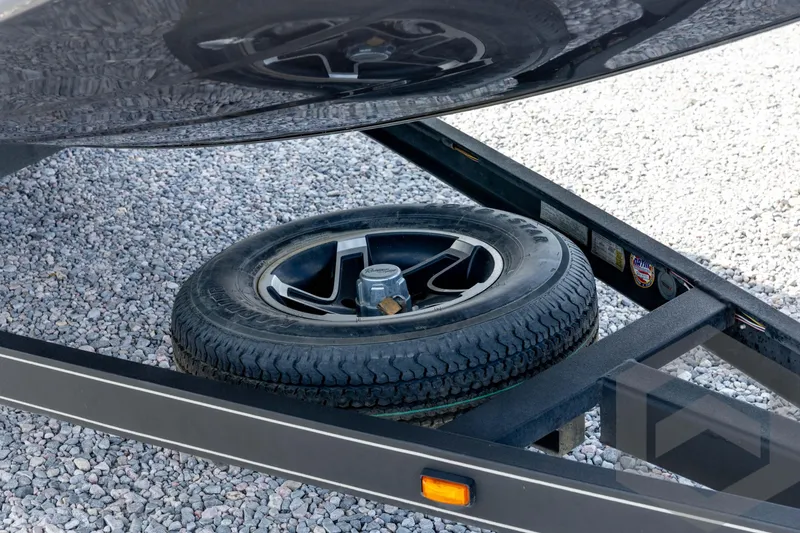 Slide: The Image of 2020 Ranger RT188P trailer with spare tire on gravel surface. - 12