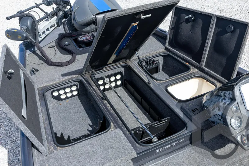 Slide: The Image of 2020 Ranger RT188P boat interior with open storage compartments and fishing equipment. - 35