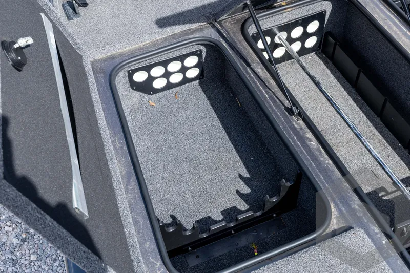 Slide: The Image of 2020 Ranger RT188P boat storage compartment with rod holders and carpeted interior. - 36