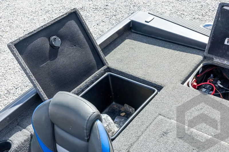 Slide: The Image of 2020 Ranger RT188P boat storage compartments with open lids on a gravel surface. - 54