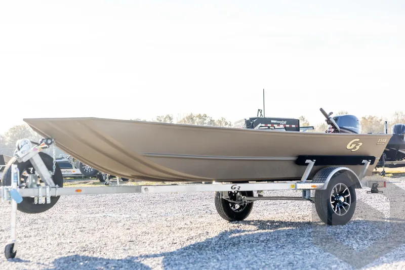 The Image of 2026 G3 Gator Tough 1548 VBW boat on trailer, parked outdoors. - 1