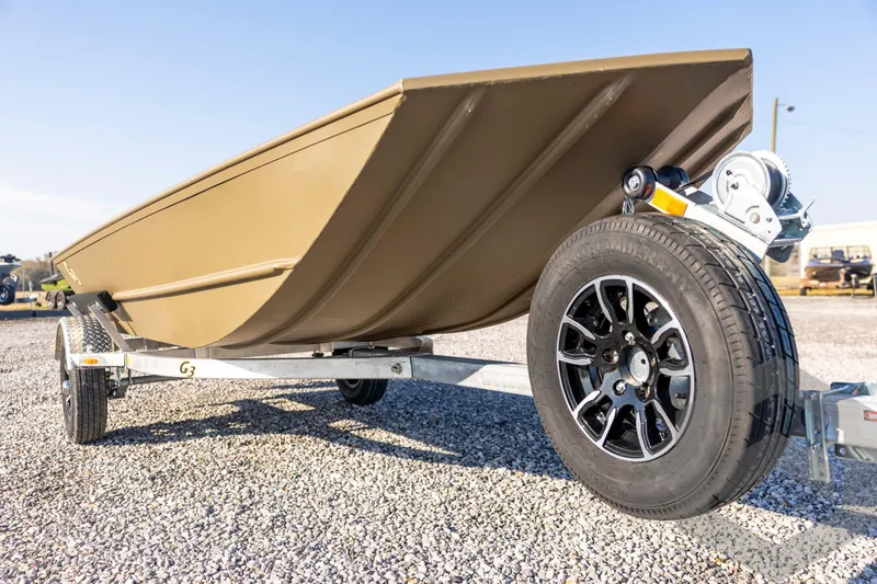 Slide: The Image of 2026 G3 Gator Tough 1548 VBW boat on trailer, gravel surface, sunny day. - 11