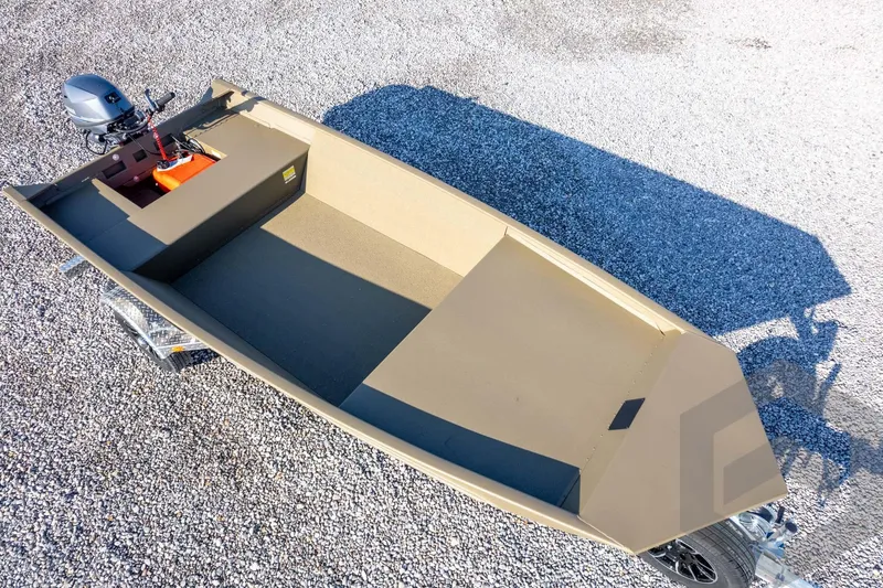 Slide: The Image of 2026 G3 Gator Tough 1548 VBW boat on gravel, featuring a compact design and outboard motor. - 34